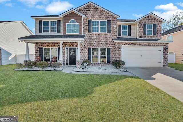 view of front of property featuring a garage, a front yard, and a porch