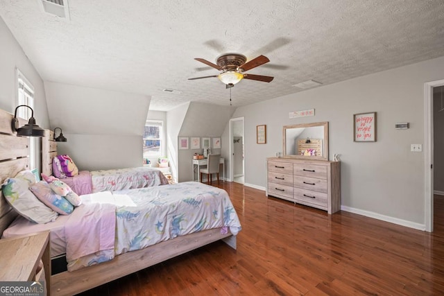 bedroom featuring dark hardwood / wood-style floors, multiple windows, and a textured ceiling