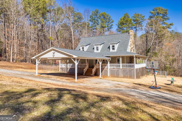 farmhouse inspired home featuring a porch and a carport