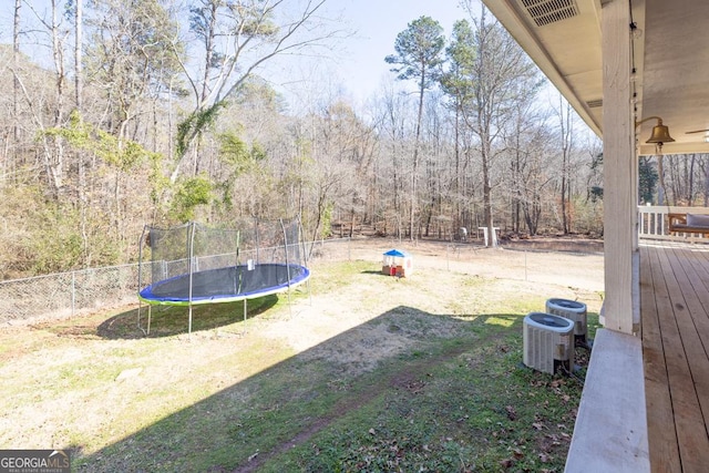 view of yard with cooling unit and a trampoline