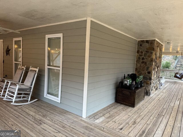 wooden terrace featuring ceiling fan