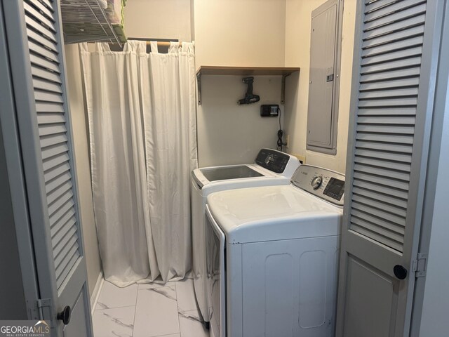 laundry area featuring electric panel and washing machine and dryer