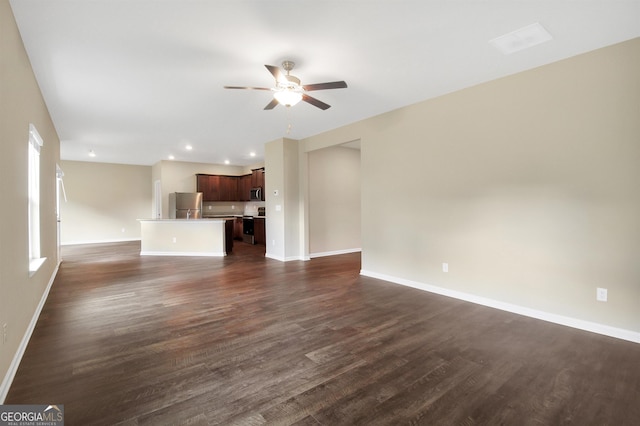 unfurnished living room featuring ceiling fan and dark hardwood / wood-style floors