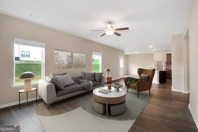 living room with dark wood-type flooring and ceiling fan