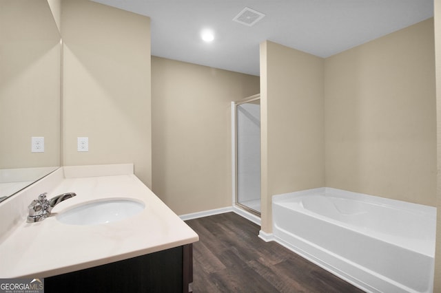 bathroom with vanity, hardwood / wood-style floors, and independent shower and bath