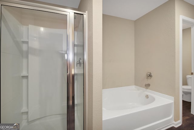 bathroom with shower with separate bathtub and toilet