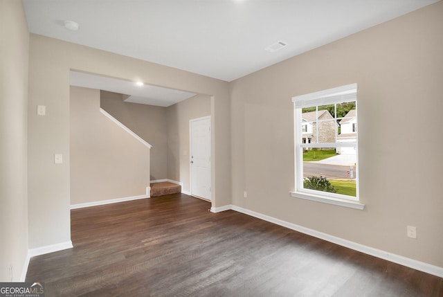 empty room featuring dark hardwood / wood-style flooring