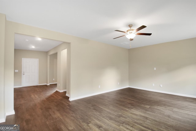 spare room with ceiling fan and dark hardwood / wood-style flooring