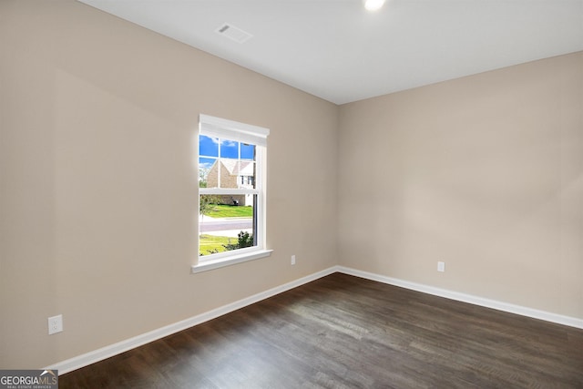 spare room with dark hardwood / wood-style flooring