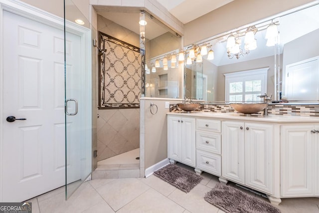 304 Stathams Way, Warner Robins, GA 31088 - full bathroom with a stall shower, double vanity, tile patterned floors, tasteful backsplash, and a chandelier