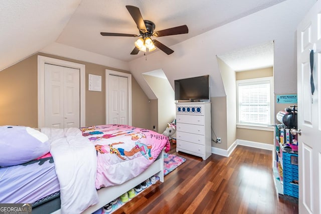304 Stathams Way, Warner Robins, GA 31088 - bedroom with vaulted ceiling, multiple closets, dark wood-type flooring, baseboards, and ceiling fan