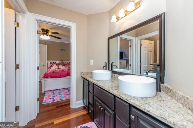 304 Stathams Way, Warner Robins, GA 31088 - ensuite bathroom featuring double vanity, wood finished floors, a ceiling fan, and a textured ceiling