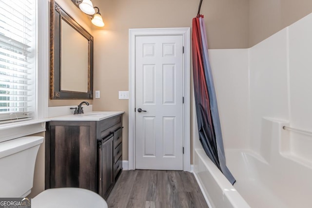 304 Stathams Way, Warner Robins, GA 31088 - bathroom featuring vanity, toilet, wood finished floors, and shower / bath combo with shower curtain