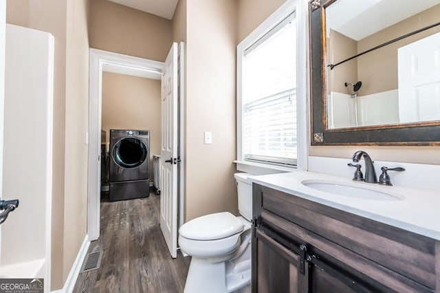 304 Stathams Way, Warner Robins, GA 31088 - full bath featuring washer / clothes dryer, toilet, wood finished floors, vanity, and a shower