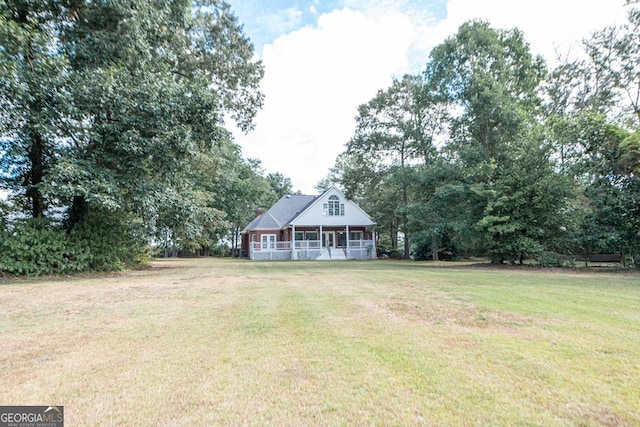304 Stathams Way, Warner Robins, GA 31088 - view of front of property with a sunroom, a front lawn, and view of wooded area