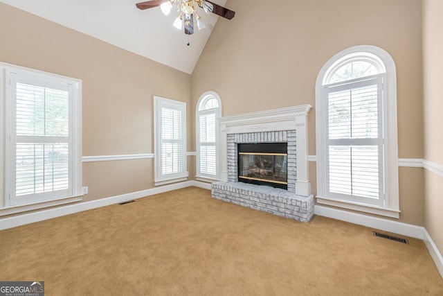 304 Stathams Way, Warner Robins, GA 31088 - unfurnished living room with ceiling fan, carpet, high vaulted ceiling, a brick fireplace, and baseboards