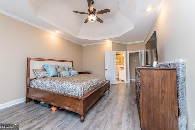304 Stathams Way, Warner Robins, GA 31088 - bedroom featuring a raised ceiling, wood finished floors, baseboards, recessed lighting, and crown molding