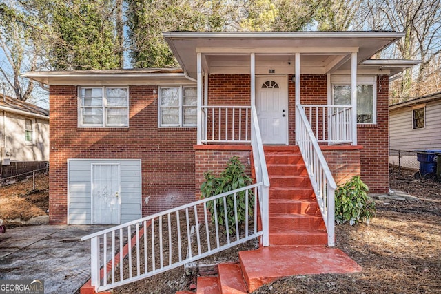 view of front of house featuring a porch and a garage