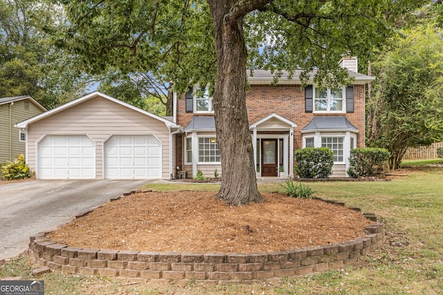 view of front of home featuring a garage and a front lawn