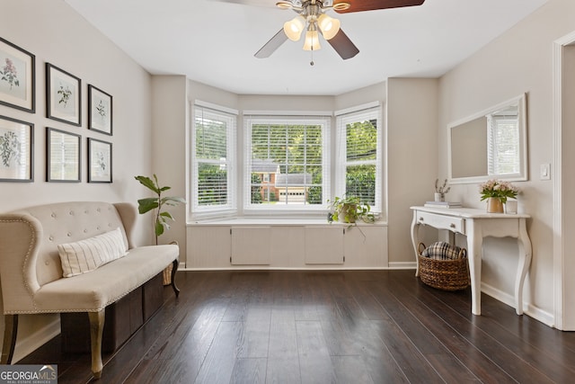 living area with dark hardwood / wood-style flooring and ceiling fan