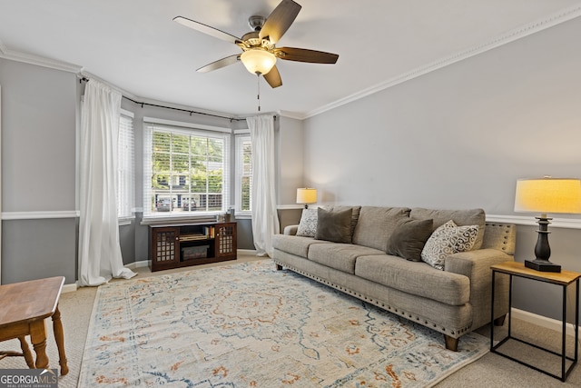 living room with ornamental molding, ceiling fan, and carpet flooring