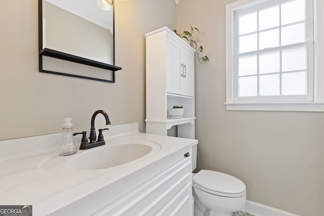 bathroom featuring vanity and toilet