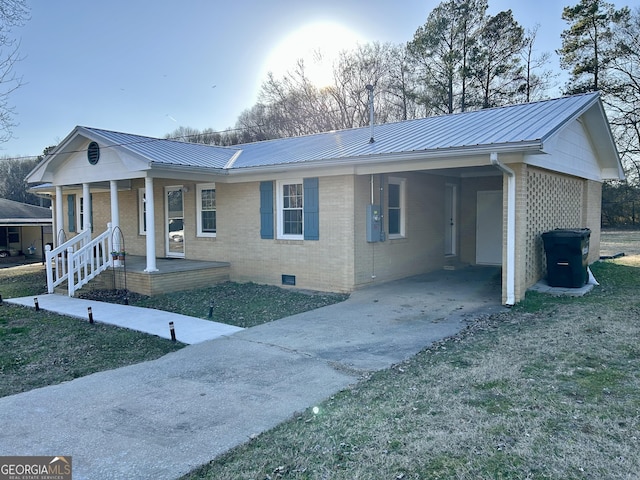 ranch-style home with a front lawn, a carport, and covered porch