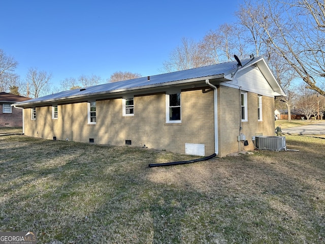 rear view of house featuring a yard and central AC unit