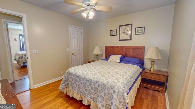 bedroom with hardwood / wood-style flooring and ceiling fan