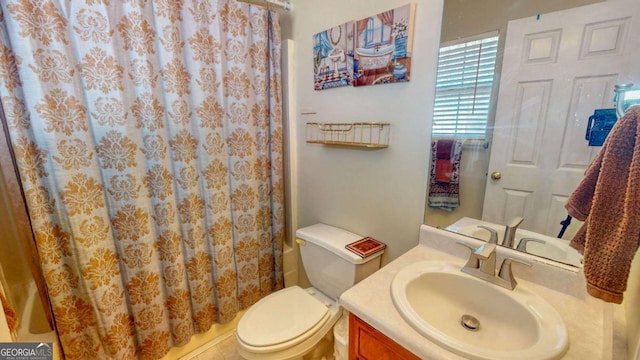 bathroom featuring vanity, curtained shower, and toilet