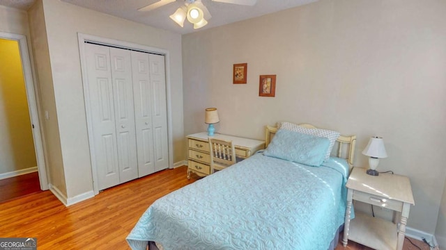 bedroom with wood-type flooring, a closet, and ceiling fan