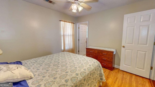 bedroom with ceiling fan and light hardwood / wood-style flooring