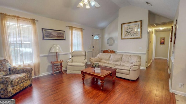 living room featuring lofted ceiling, ceiling fan, dark hardwood / wood-style floors, and a healthy amount of sunlight