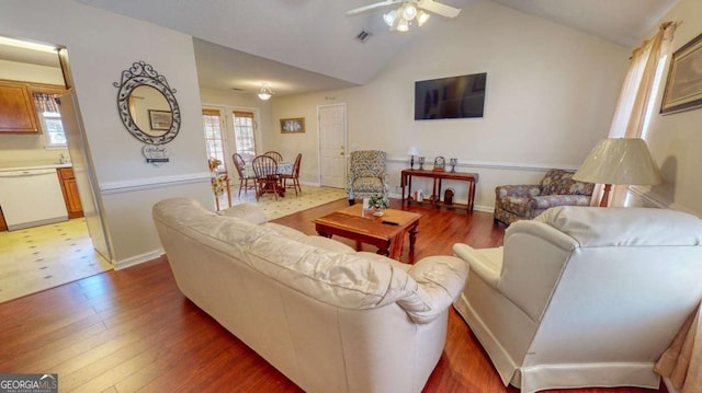 living room featuring hardwood / wood-style flooring, lofted ceiling, and ceiling fan