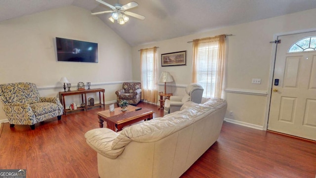 living room with ceiling fan, dark hardwood / wood-style flooring, and vaulted ceiling