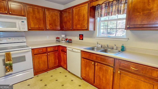 kitchen featuring white appliances and sink