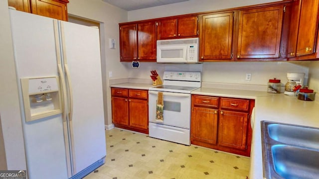 kitchen with sink and white appliances