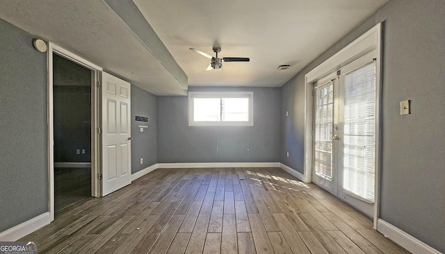 spare room with wood-type flooring and ceiling fan