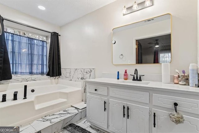 bathroom featuring vanity and a tub