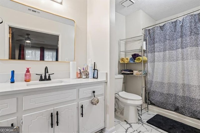 bathroom featuring toilet, a textured ceiling, vanity, curtained shower, and ceiling fan