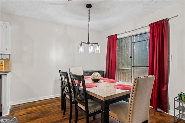 dining space with a textured ceiling and dark hardwood / wood-style flooring