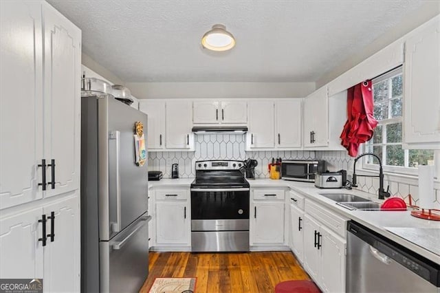 kitchen with sink, stainless steel appliances, and white cabinets