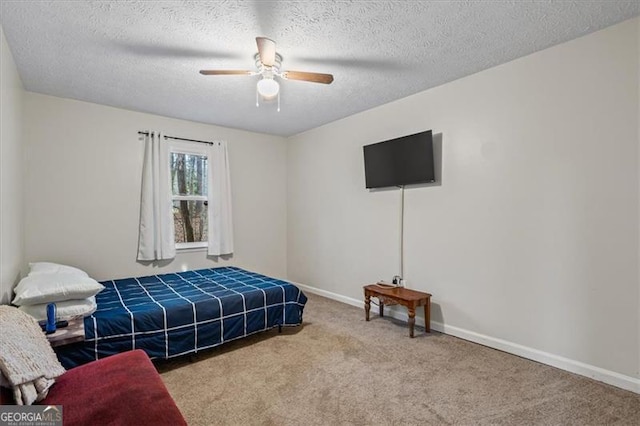 carpeted bedroom with ceiling fan and a textured ceiling