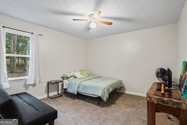 bedroom featuring ceiling fan, light carpet, and a textured ceiling