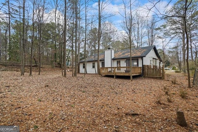 back of property featuring a wooden deck