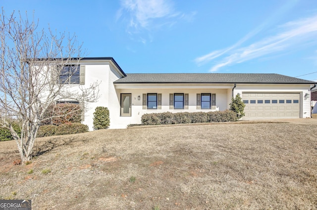 view of front of house with a garage and a front yard