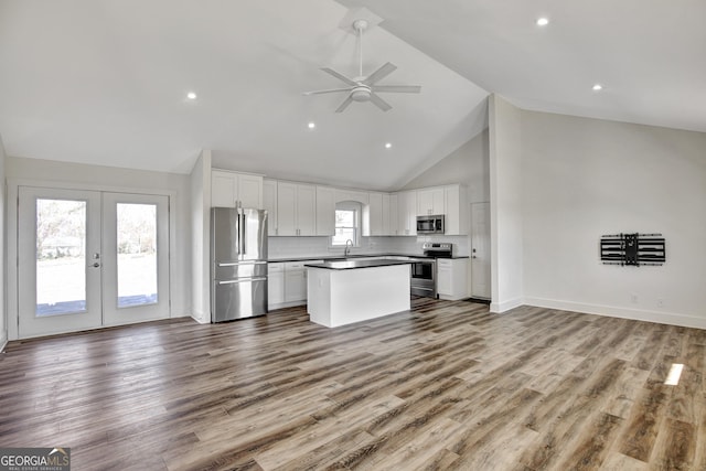 kitchen with white cabinetry, hardwood / wood-style floors, and appliances with stainless steel finishes