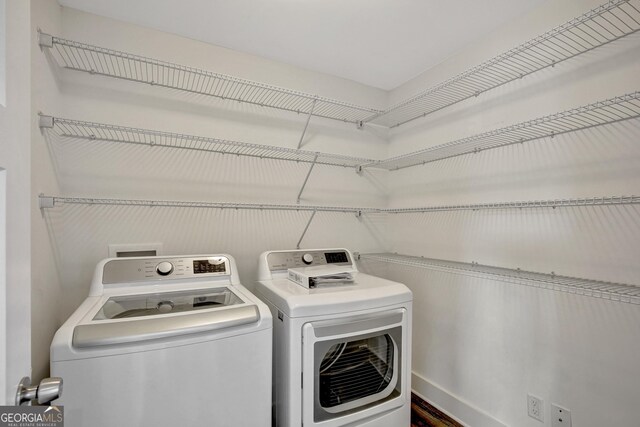 clothes washing area featuring washer and dryer