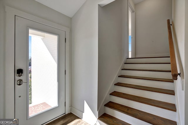 stairs featuring hardwood / wood-style flooring