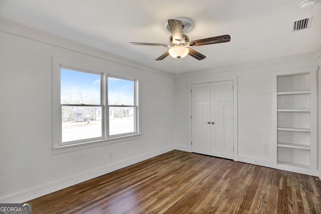 unfurnished bedroom with wood-type flooring, a closet, and ceiling fan